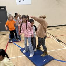 Division 1 were trying to get to the other side of the gym using mats. they had to work together and communicate. They did it!!